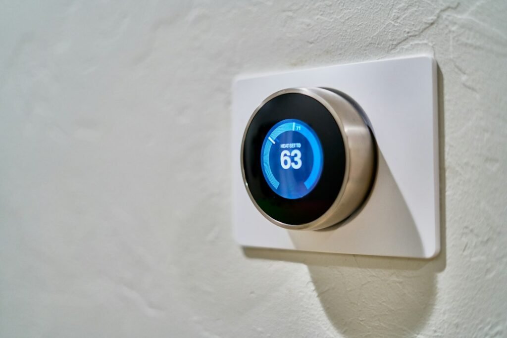 Wall-mounted thermostat with a blue temperature display
